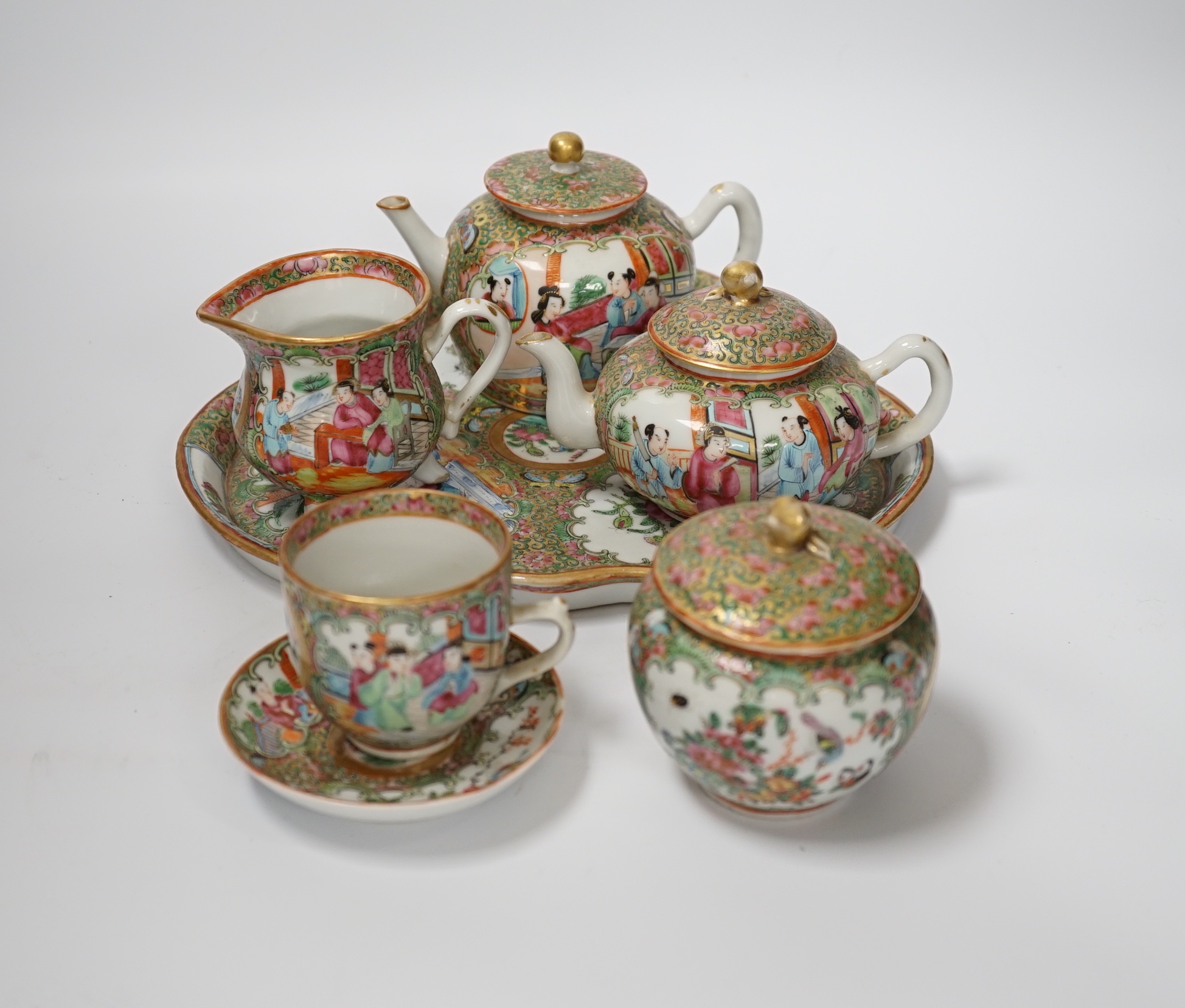 A 19th century Chinese famille rose teaset including a trefoil shaped tray, two teapots, sugar bowl, jug and cup with saucer, teapot 10cm high (6)